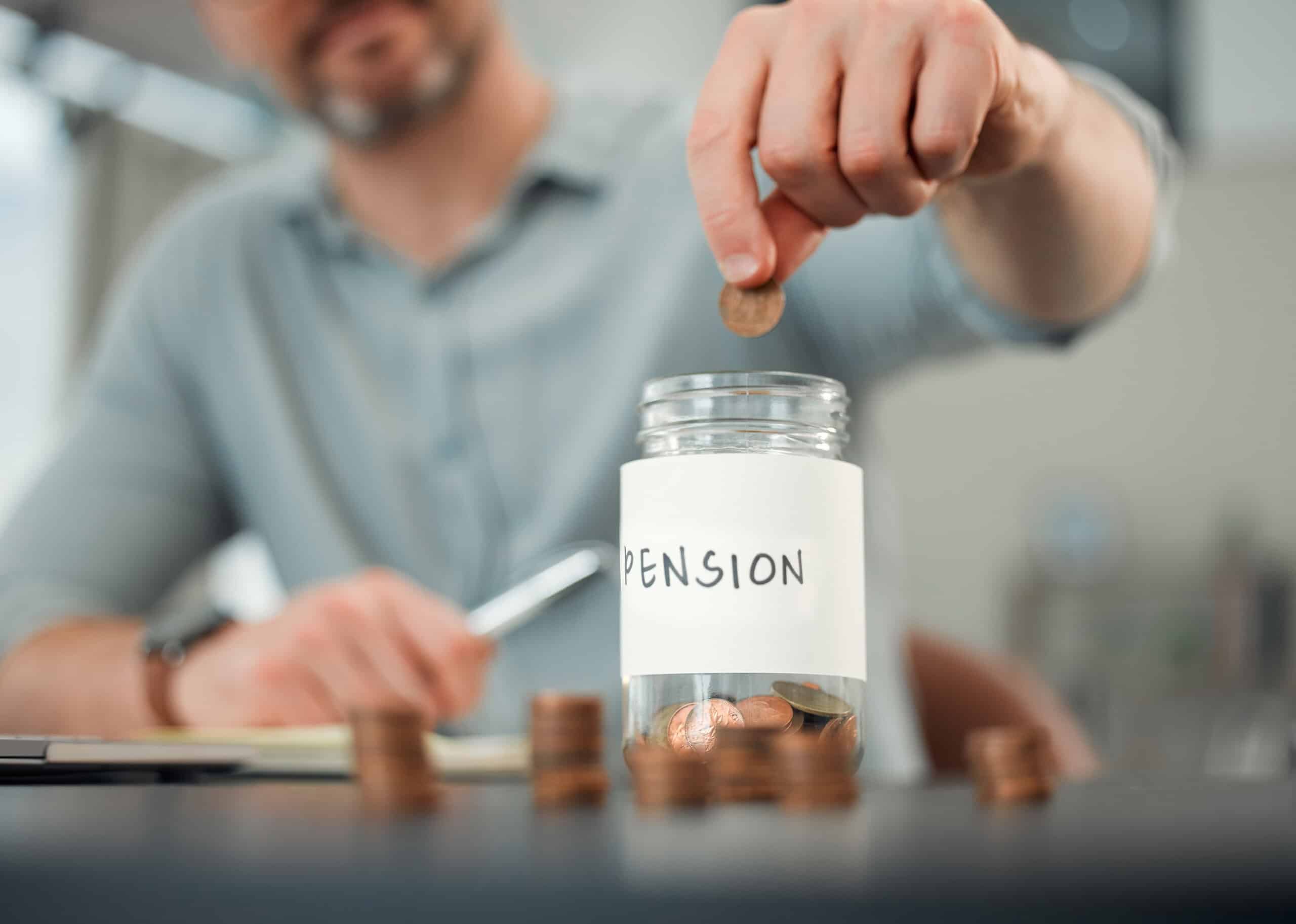 Person putting pennies in a jar